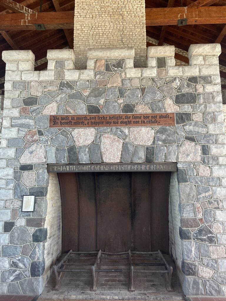 A large stone fireplace with Icelandic inscription above the hearth.