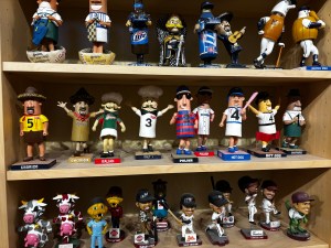 A collection of bobbleheads from the Milwaukee Brewers franchise including some players from the Timber Rattlers, and several versions of Fang, the Udder Tugger, Bernie Brewer, and the Racing Sausages.